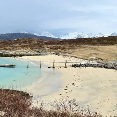A turquoise bay and jetty on Kvaloya