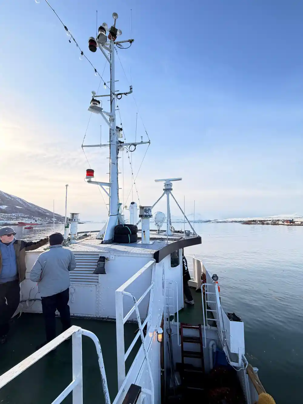 The ship's mast and upper deck with the town behind