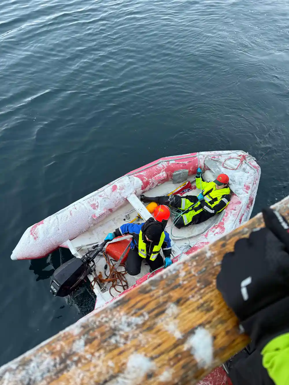 A small tender and flotation gear seen from the deck above
